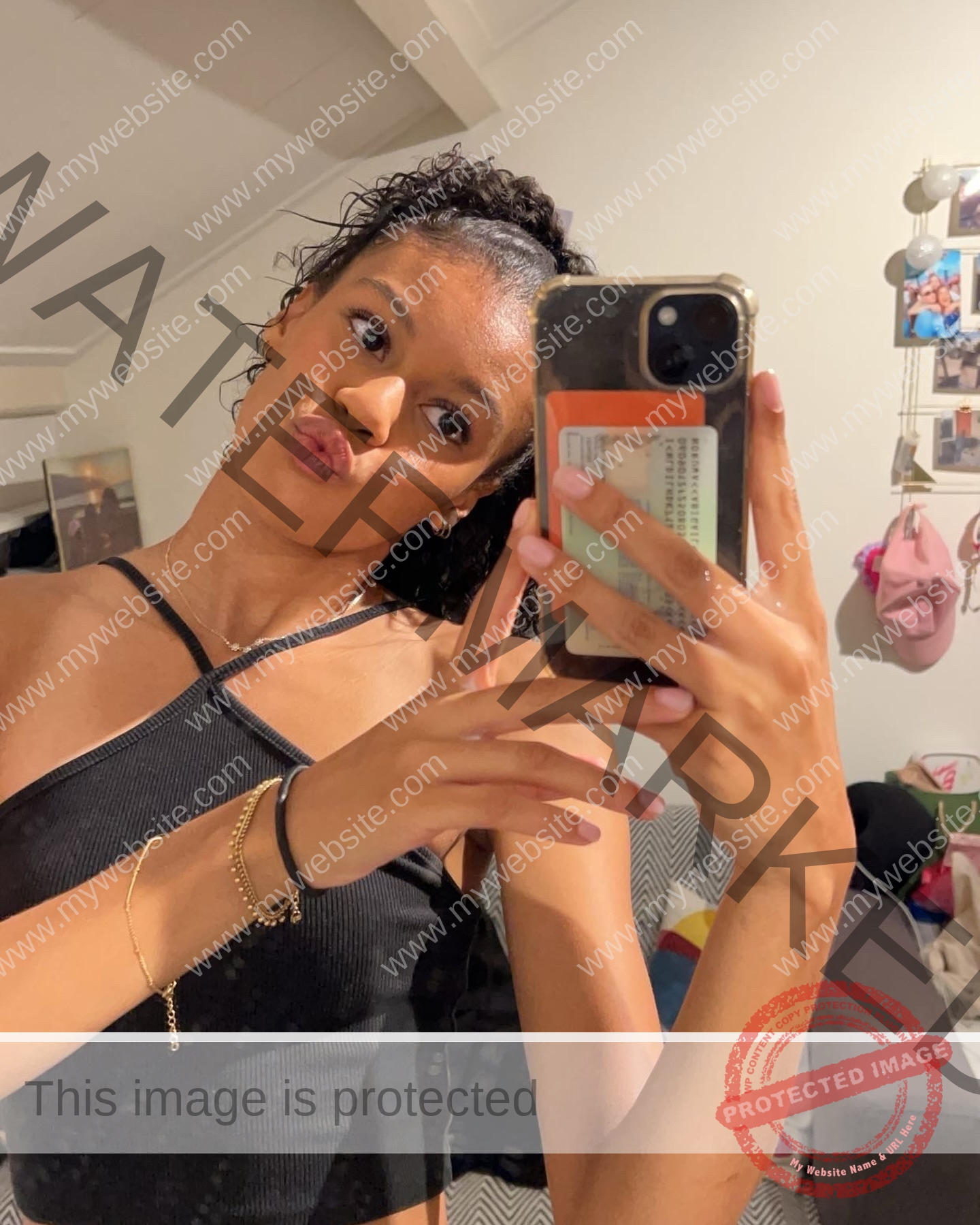 abigail-noruwa-netherlands-abigail_noruwa-u20-x-00038 Abigail Noruwa, track star from the Netherlands, takes a mirror selfie in black top and gold bracelet, making a playful duck face.