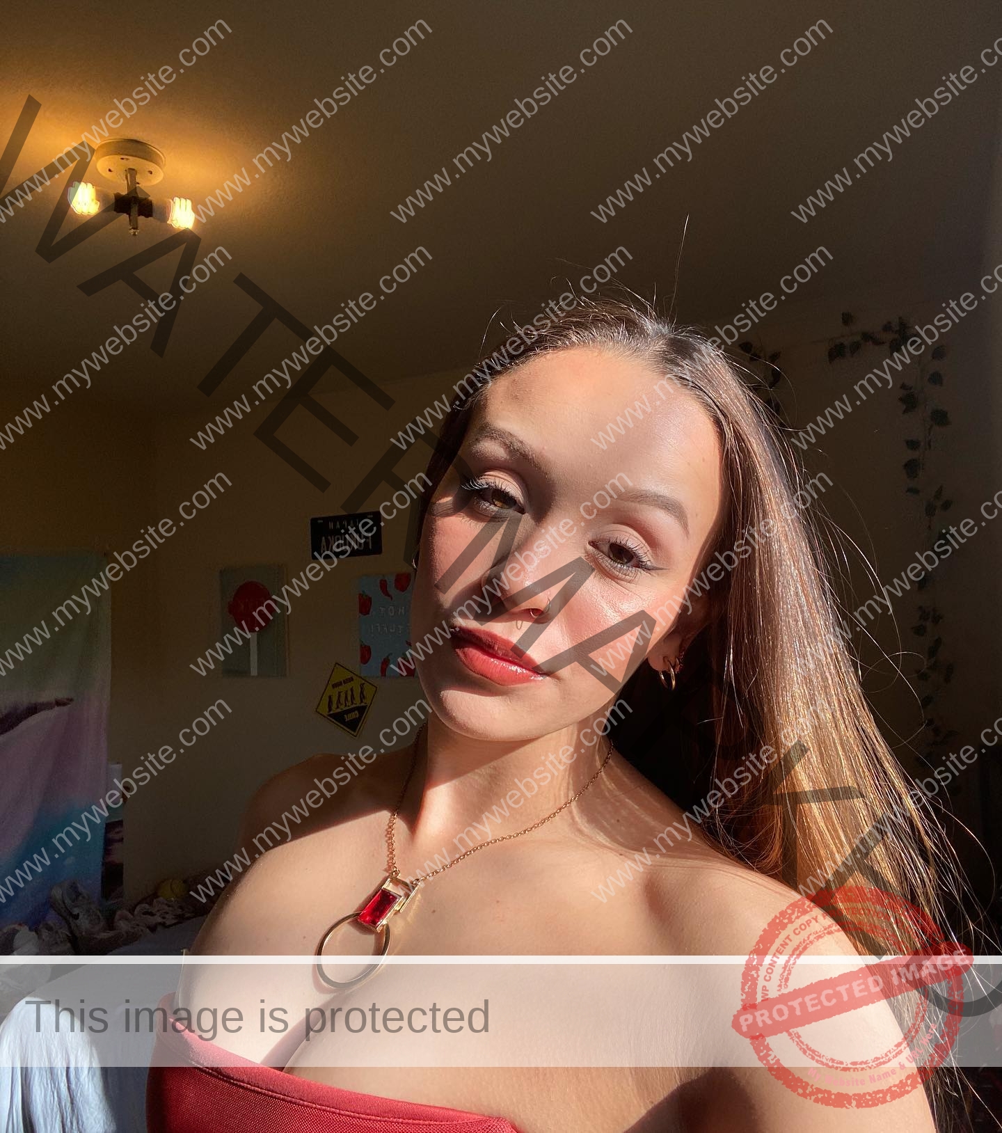 alondra-ortiz-costa-rica-alortizroman-556 Alondra Ortiz stands in a sunlit room with long light brown hair, red strapless top, and Costa Rica-inspired relaxed décor behind her.