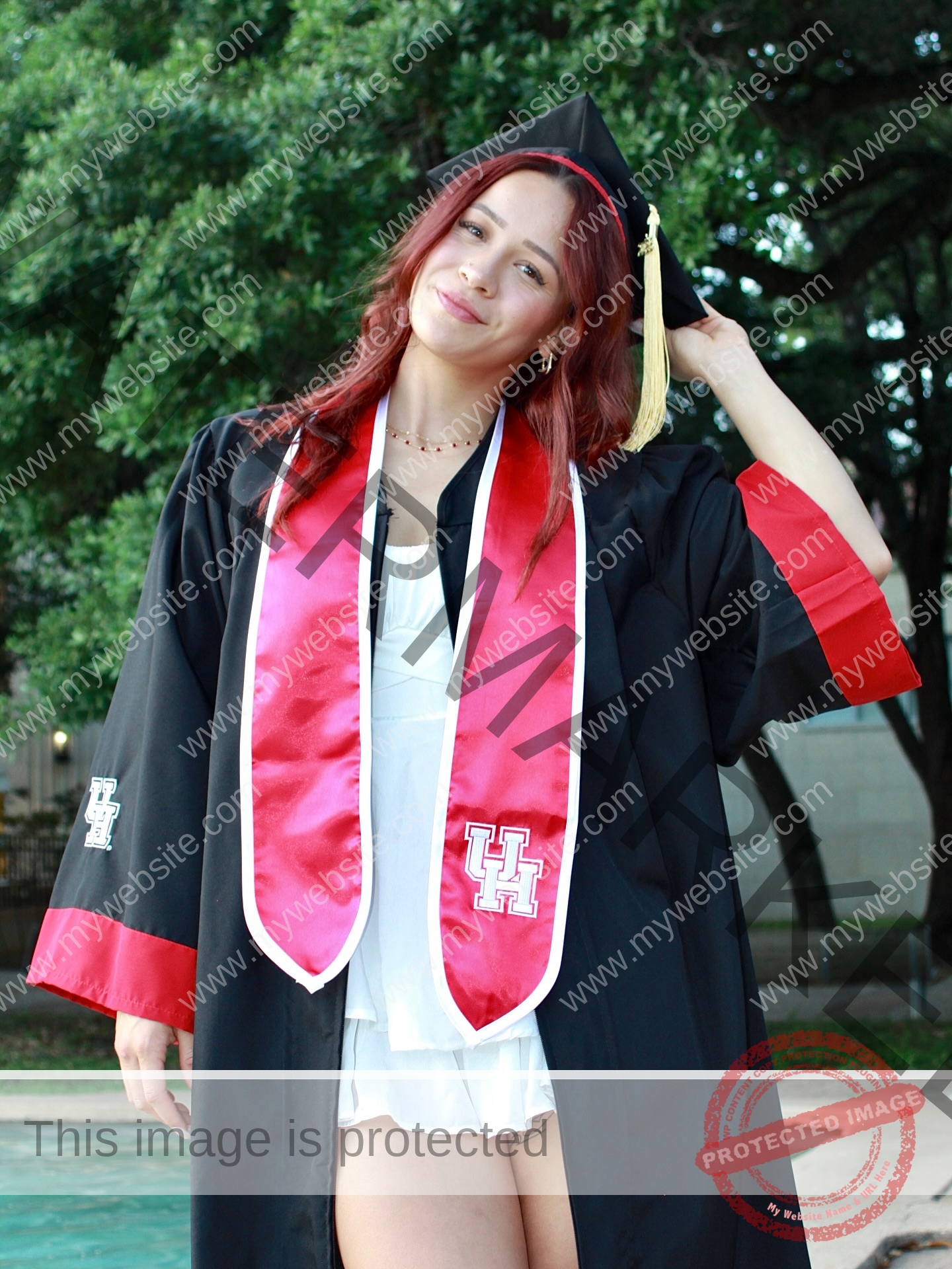alondra-ortiz-costa-rica-alortizroman-684 Alondra Ortiz A young woman, a swimming champion from Costa Rica, stands outside in a black gown and red-trimmed stole, smiling with cap.