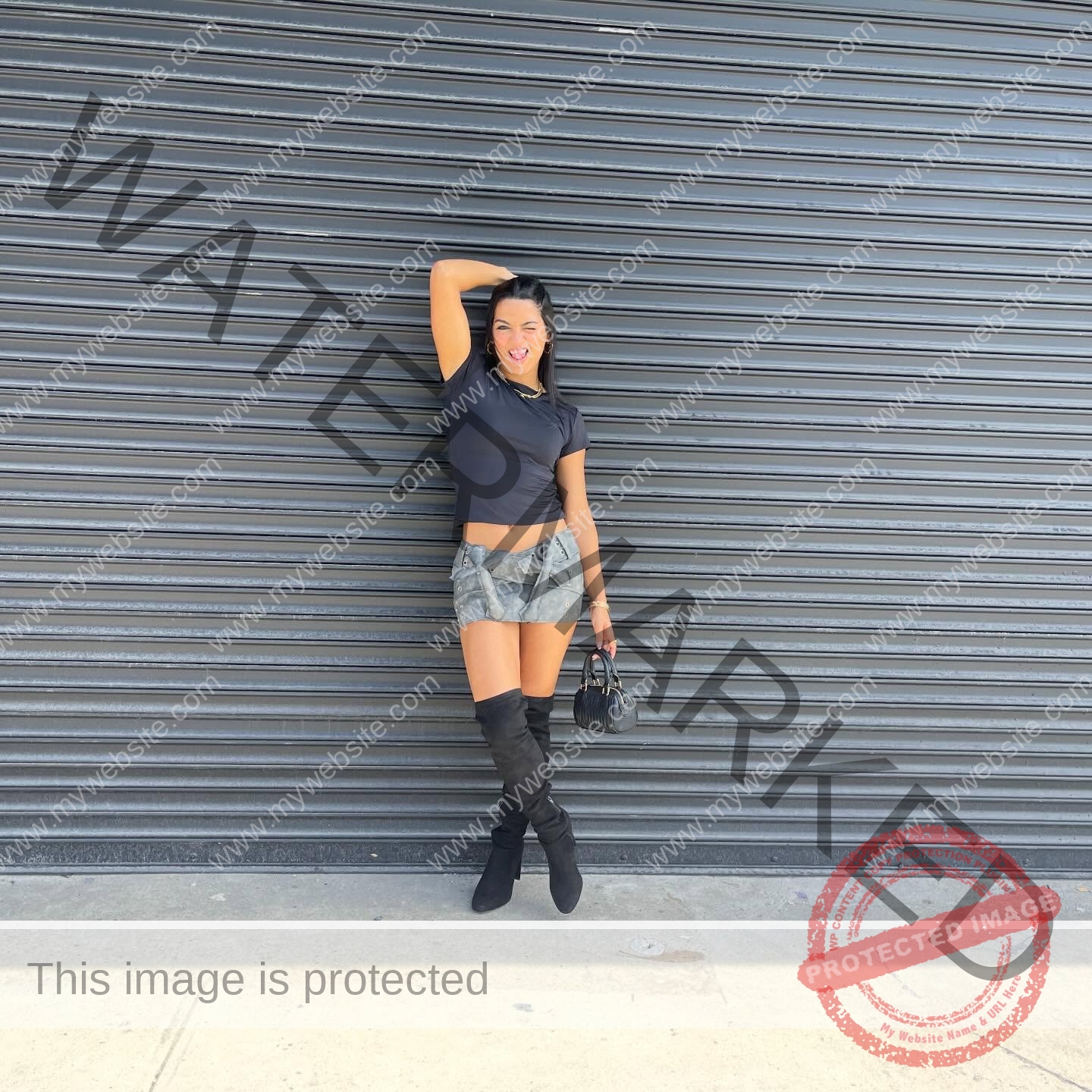 andrea-rivera-aviles-puerto-rico-aandrea.sofiaa-05901 Andrea Rivera Aviles, track athlete from Puerto Rico stands before a metal shutter in a crop top, mini skirt, boots, and smiles.