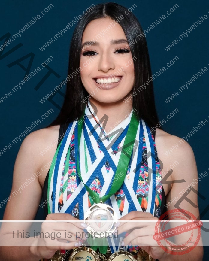 Andrea Sosa, track star from Nicaragua, smiles with a medal and colorful top, wearing several medals on blue, green, and white ribbons.