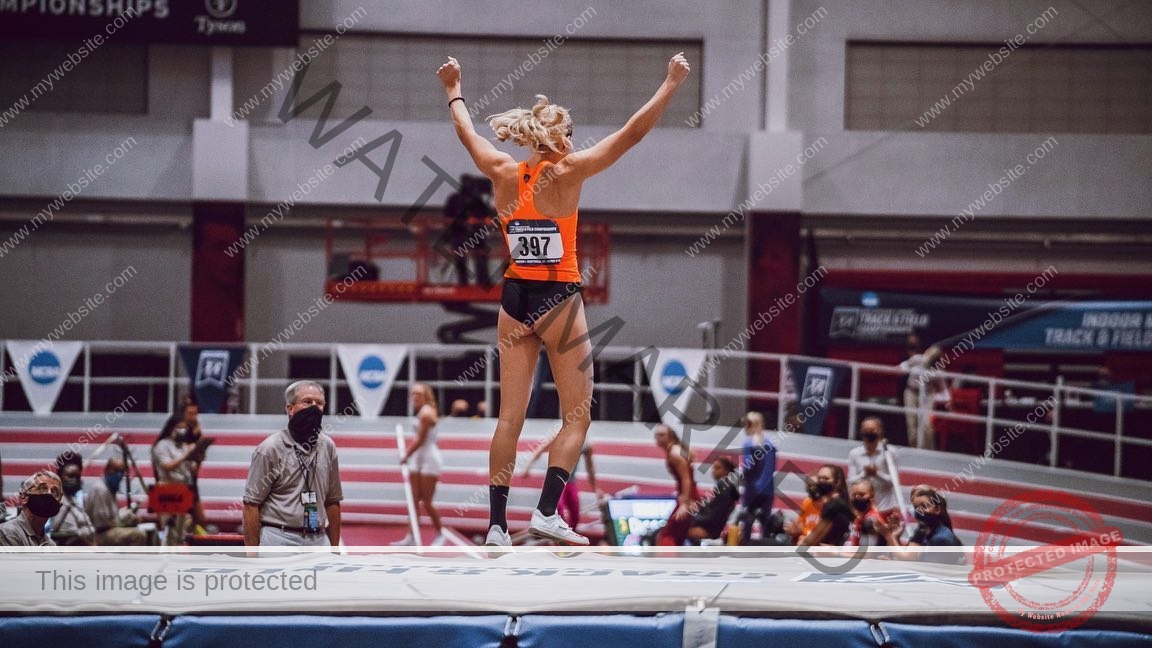 ariadni-adamopoulou-greece-ariadni_adam-08988 Ariadni Adamopoulou, pole vaulter from Greece and Oklahoma State, celebrates with arms raised after a pole vault event indoors.