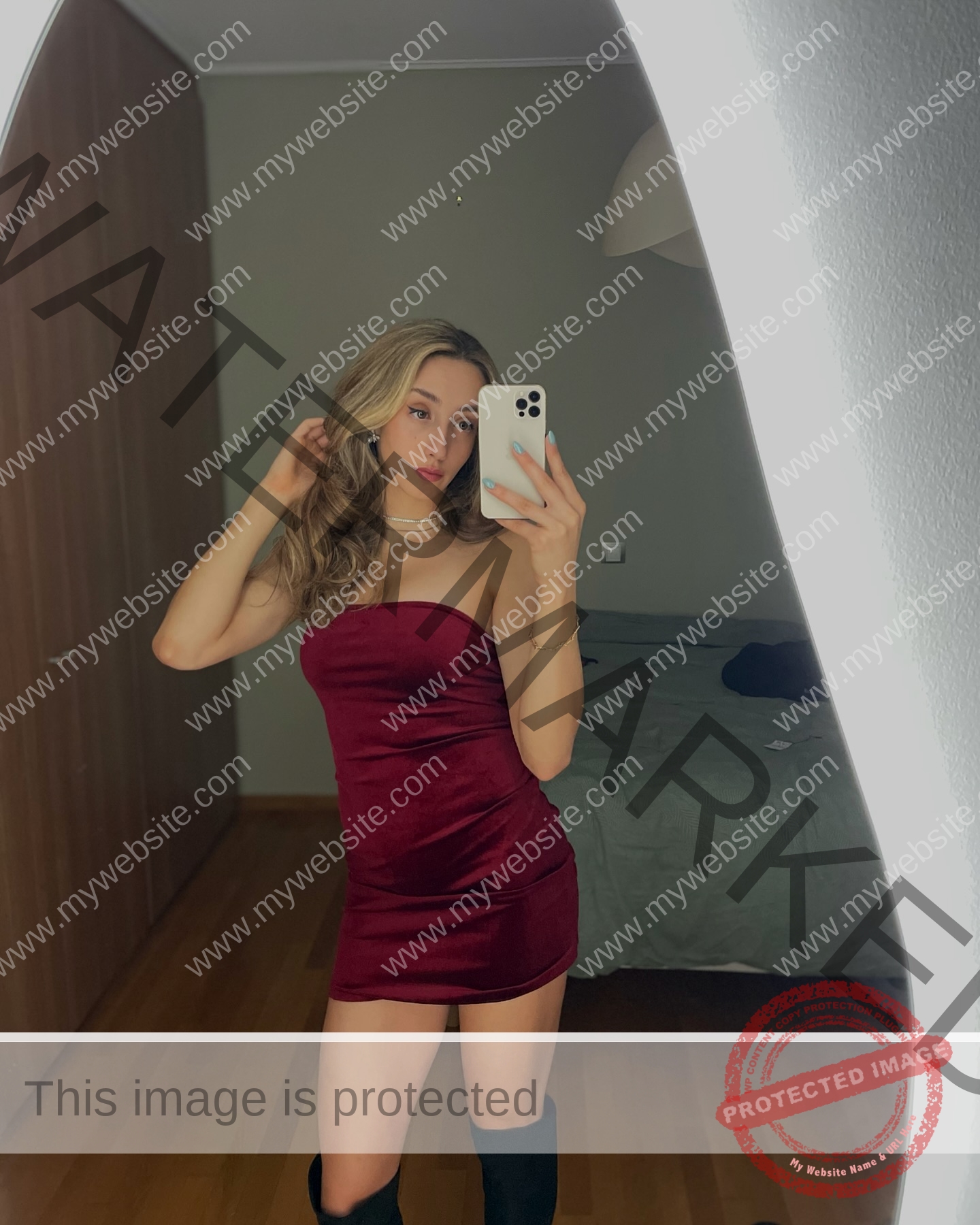 ariadni-adamopoulou-greece-ariadni_adam-09119 Ariadni Adamopoulou, pole vaulter from Greece, takes a mirror selfie in a strapless burgundy dress and black boots in her bedroom.