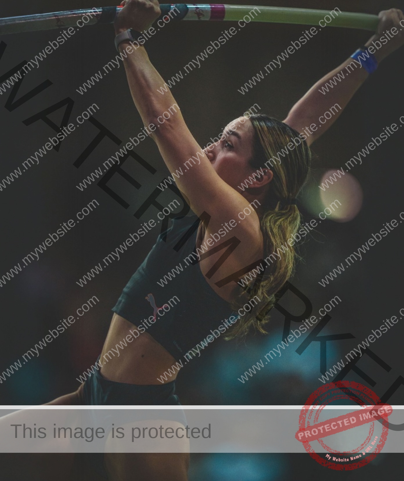 ariadni-adamopoulou-greece-ariadni_adam-09124 Ariadni Adamopoulou, pole vaulter from Greece, grips the pole in athletic gear, ready to launch upward at an indoor competition.