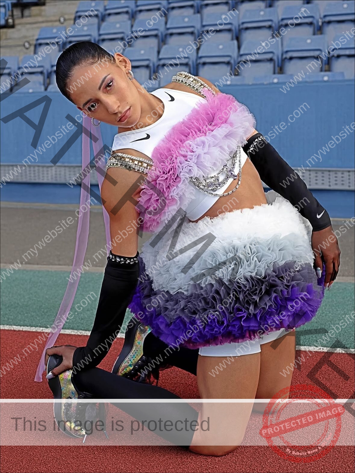 arie-aoki-japan-aokiarie_-x-09191 Arie Aoki, track star from Japan, kneels on a track in a dramatic ruffled purple, white, and black dress with gloves and heels.