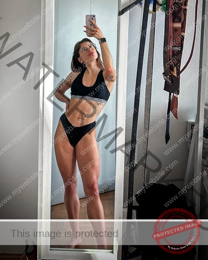 Beatrice Benaglia Beatrice Benaglia, a track and field athlete from Italy, takes a mirror selfie in a room in black sports bra and underwear.