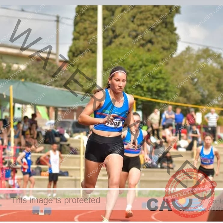 brandy-romero-uruguay-brandy_rom08-0023 Brandy Romero Brandy Romero, a talented track and field athlete from Uruguay in blue sportswear, sprints on a red track during a race.