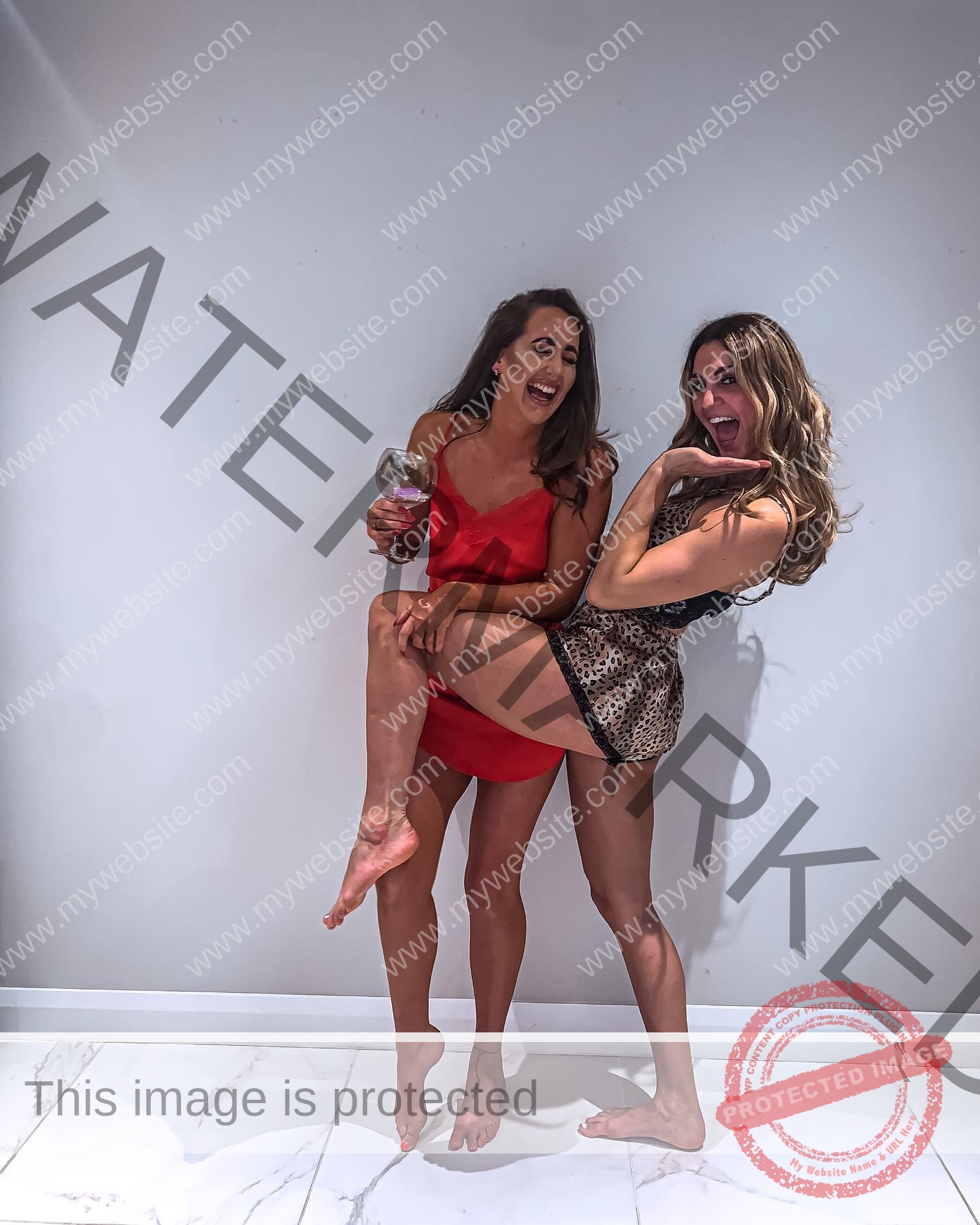 charlotte-wingfield-malta-charlottewingfield.oly-03712 Charlotte Wingfield, track athlete from Malta, laughs barefoot with a friend; both in nightwear, one in red holds a wine glass.