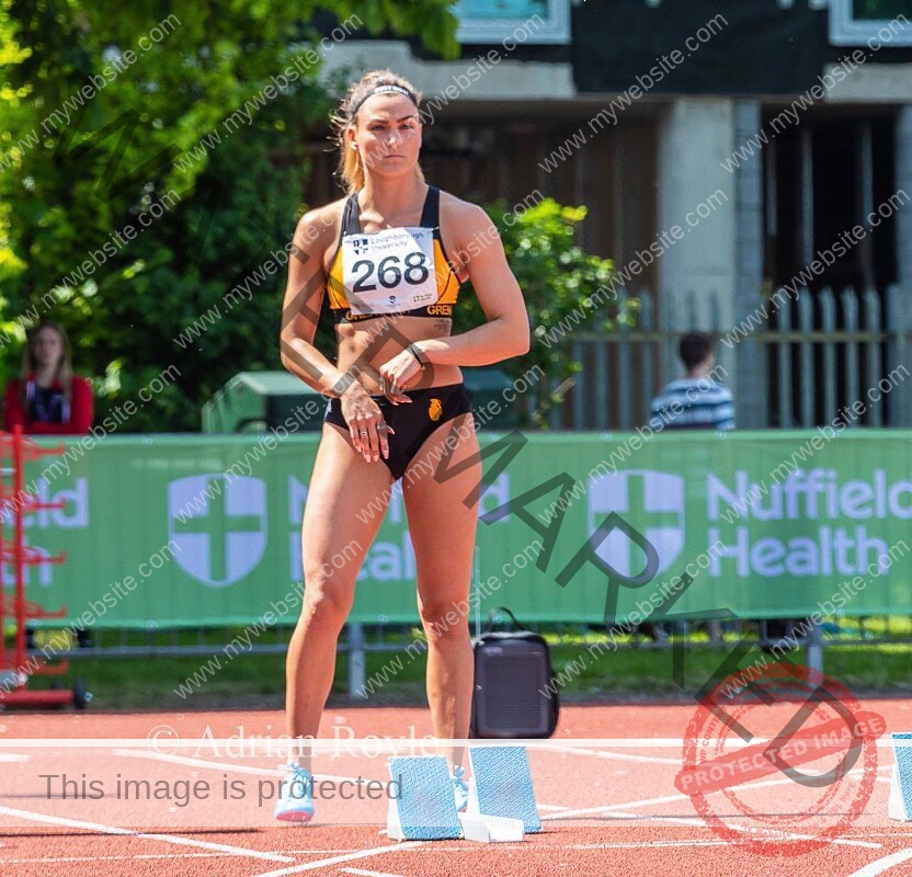 charlotte-wingfield-malta-charlottewingfield.oly-03797 Charlotte Wingfield, track athlete from Malta, in a black sports outfit and bib 268 stands focused at starting blocks on the track.