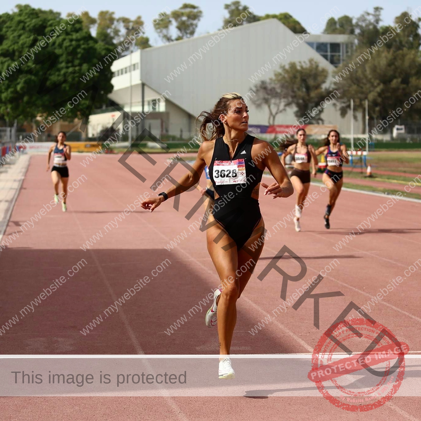 charlotte-wingfield-malta-charlottewingfield.oly-03945 Charlotte Wingfield, track athlete from Malta, crosses a finish line on an outdoor track, glancing back at other runners as she wins.