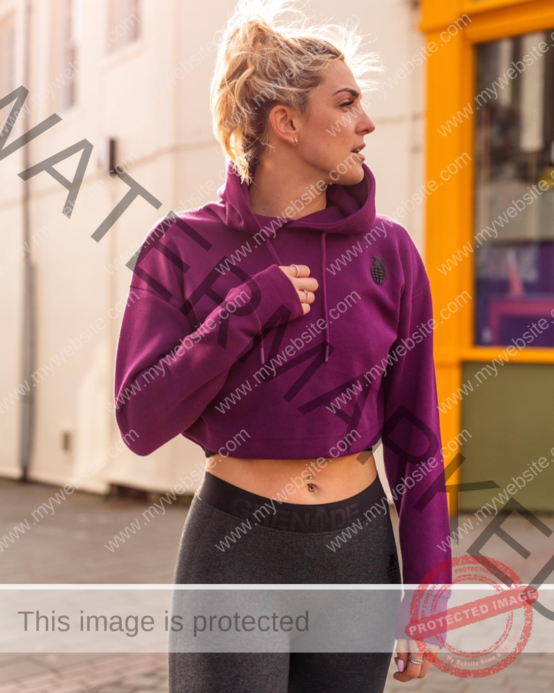 charlotte-wingfield-malta-charlottewingfield.oly-03981 Charlotte Wingfield, track athlete from Malta, in a purple cropped hoodie and gray leggings outdoors, looking aside on a sunny day.