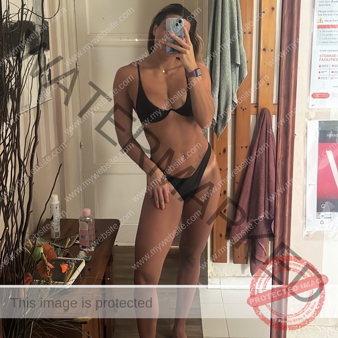 charlotte-wingfield-malta-charlottewingfield.oly-03997 Charlotte Wingfield, track athlete from Malta, wears a black bikini and takes a mirror selfie; face partly hidden by phone, room visible.