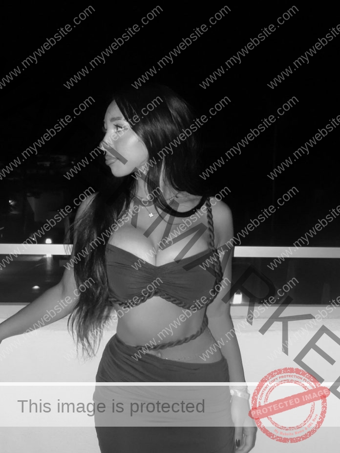 Clara Oliveira Clara Oliveira, with long dark hair in a strappy dress, stands on a balcony at night in Portugal, gazing over city lights.