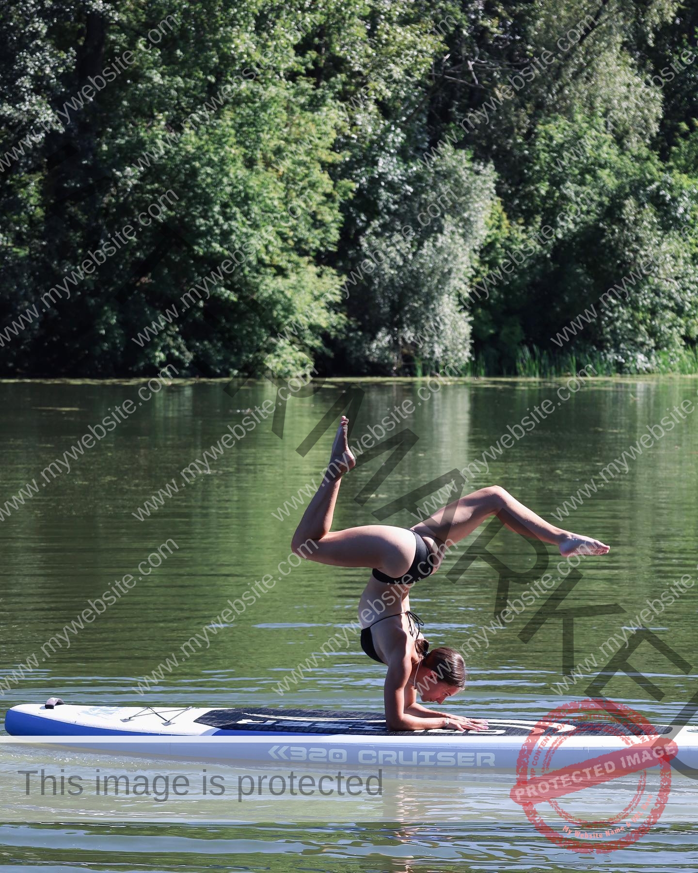 diana-honcharenka-ukraine-goncharenko_43-09721 Diana Honcharenka, track athlete from Ukraine performs a headstand yoga pose on a paddleboard on a calm river by dense trees.