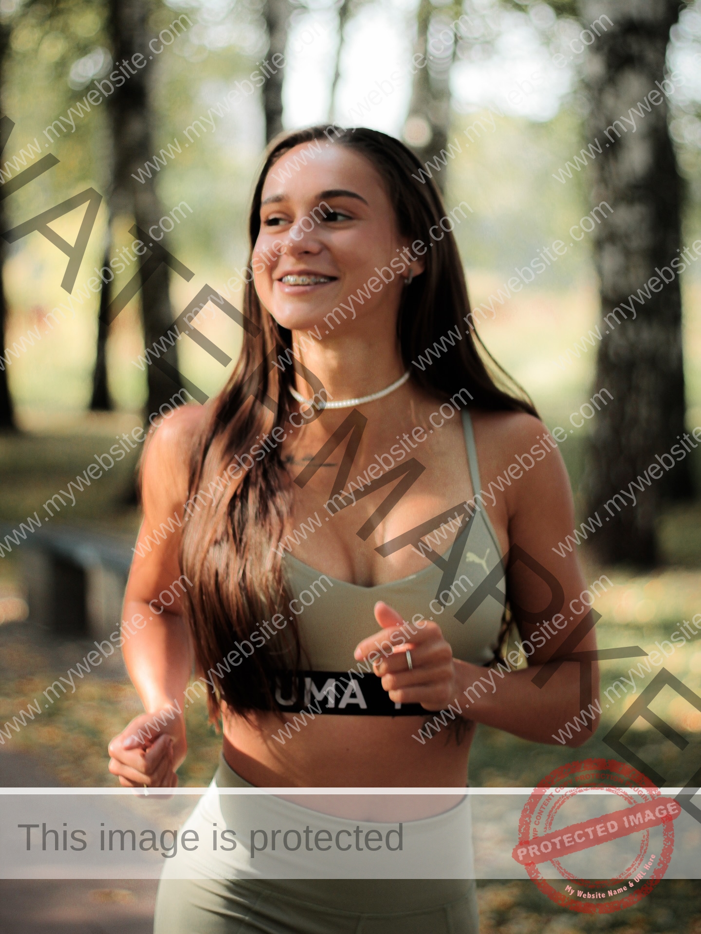 diana-honcharenka-ukraine-goncharenko_43-09953 Diana Honcharenka, track athlete from Ukraine, with long brown hair in green workout gear, runs smiling in a tree-filled park.