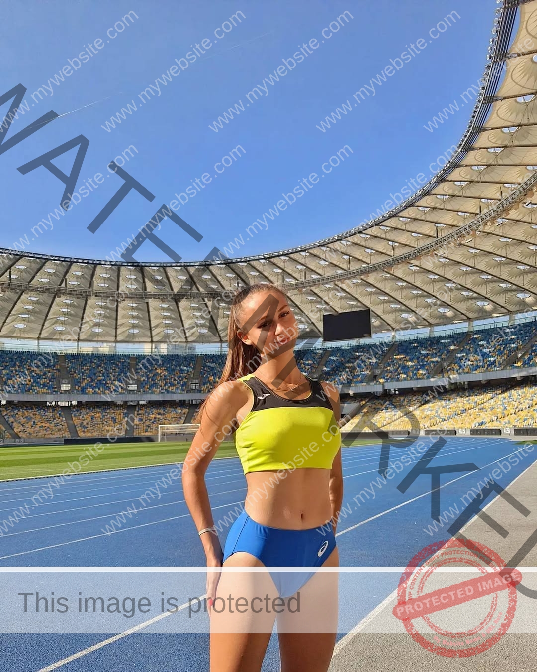diana-honcharenka-ukraine-goncharenko_43-10089 Diana Honcharenka, track athlete from Ukraine, in yellow top and blue shorts on a stadium track, smiles at the camera under sunny sky.