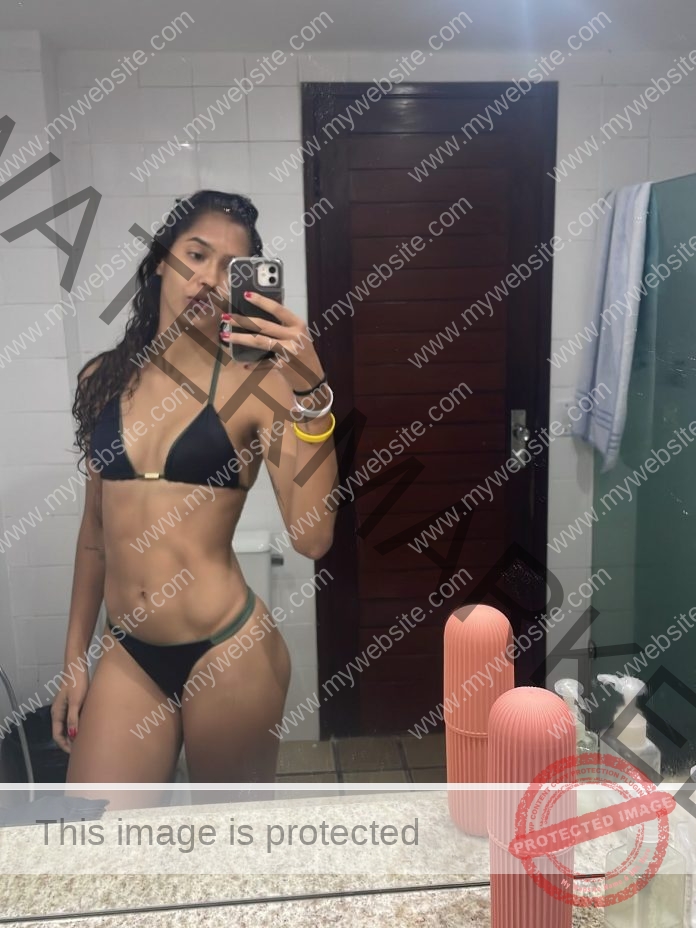 Hellen Carneiro Hellen Carneiro, a volleyball enthusiast from Brazil, takes a mirror selfie in a black bikini in a bathroom.