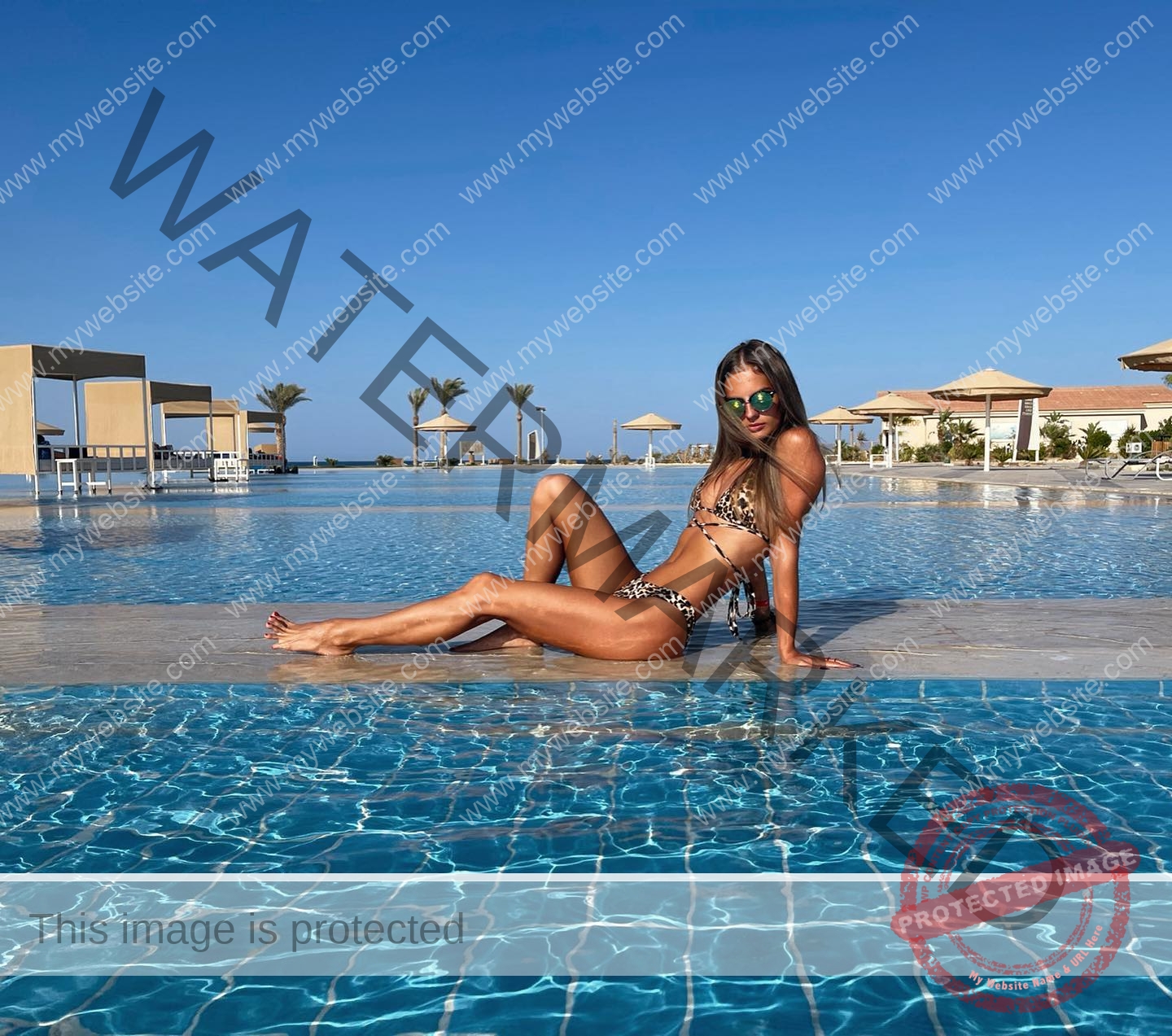 karolina-manasova-czechia-karolina_manasova-321 Karolina Manasova Karolina Manasova, a Czech track athlete, relaxes in a leopard bikini by a pool with palm trees and cabanas.