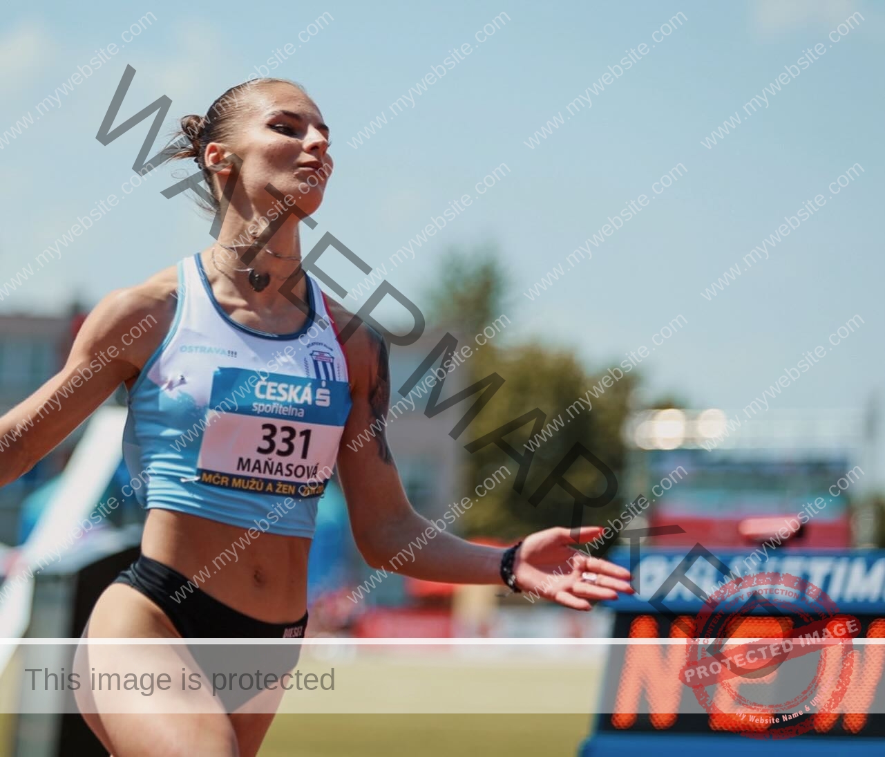 karolina-manasova-czechia-karolina_manasova-355 Karolina Manasova Karolina Manasova, a Czech track and field athlete, celebrates outdoors in blue and white, number 331 visible.
