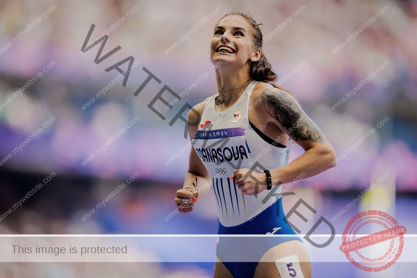 karolina-manasova-czechia-karolina_manasova-360 Karolina Manasova A female track and field athlete from the Czech Republic, Karolina Manasova, smiles and celebrates in a white and blue PARASOVA Olympic uniform, showing her arm tattoo and bib 5.
