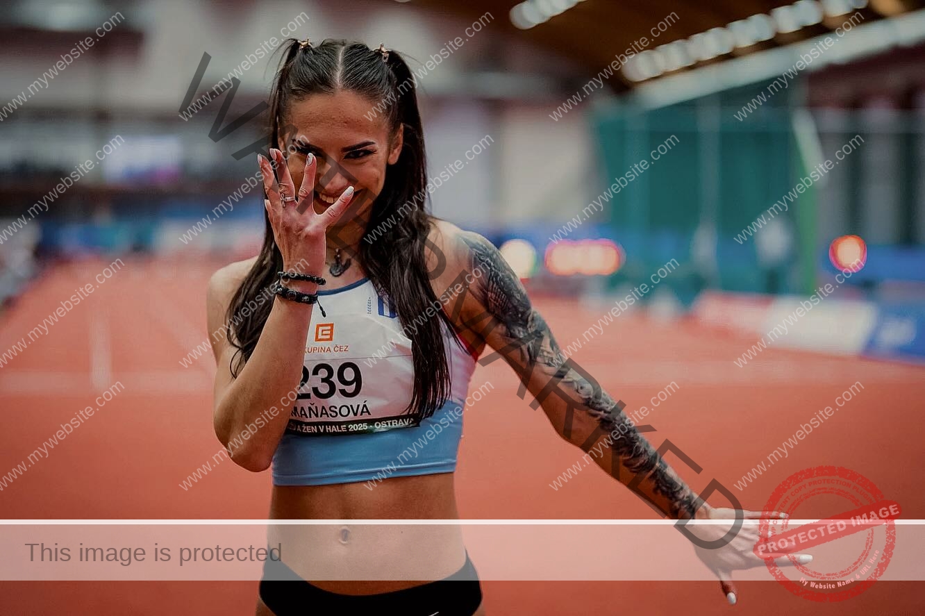 karolina-manasova-czechia-karolina_manasova-372 Karolina Manasova Track and field athlete Karolina Manasova smiles on an indoor track, playfully covering her face before the 100m event.