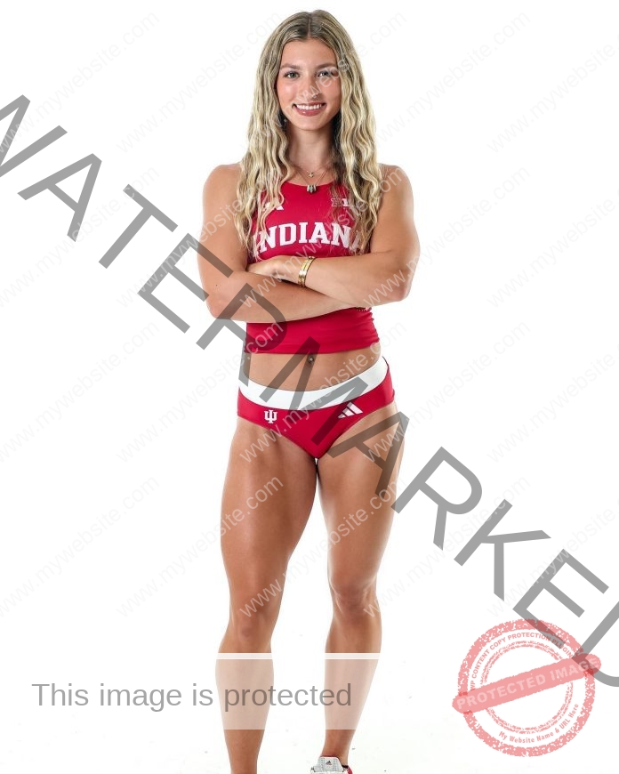 Kylee Poulton Indiana track and field athlete Kylee Poulton stands confidently with arms crossed, smiling in her red Indiana University uniform against a plain white background.
