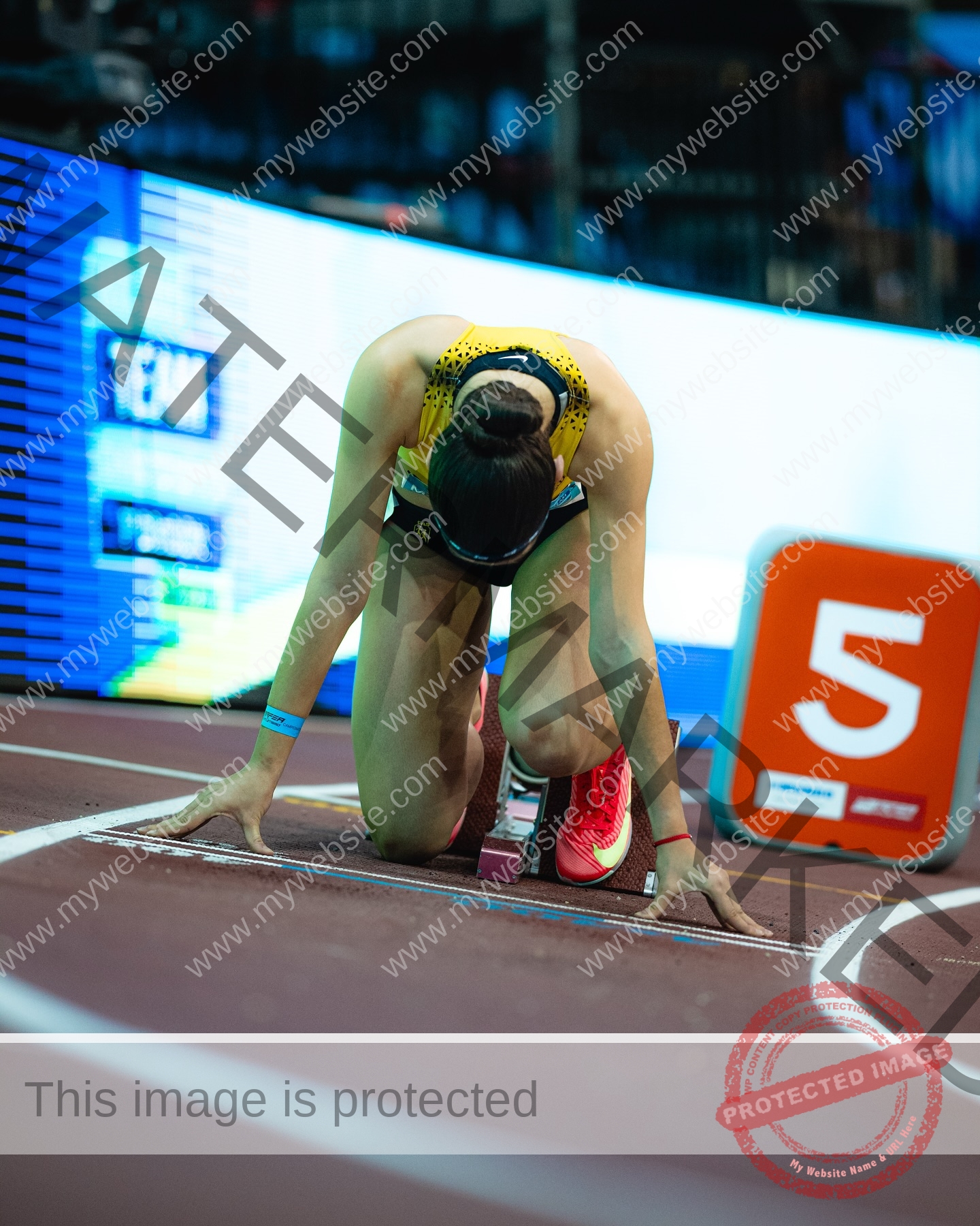 laura-castillo-spain-laura_c.i_-3278 Laura Castillo Laura Castillo of Spain, in yellow and black, kneels at lane 5’s start line, focused, head down, hands on the ground.