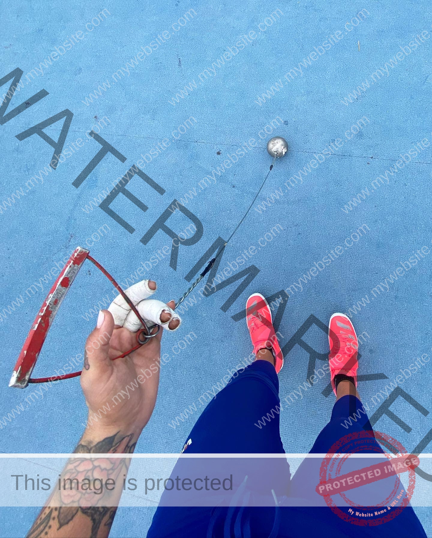 mariana walker-childe-marianawalker_-1685 Mariana Walker, hammer thrower from Chile, stands in blue pants and pink sneakers on blue, holding an épée; tattoo on forearm visible.