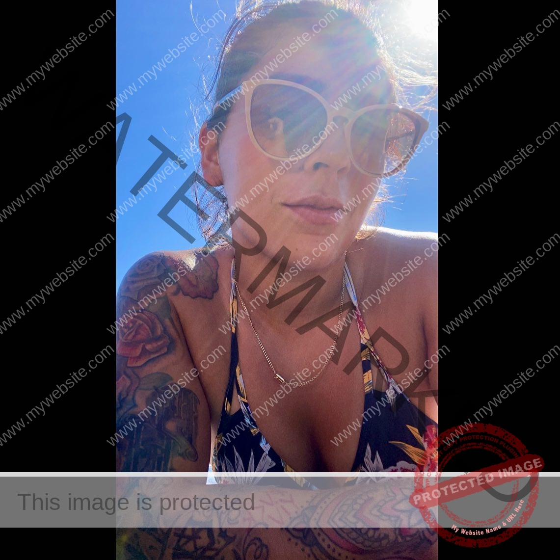 mariana walker-childe-marianawalker_-1721 Mariana Walker, hammer thrower from Chile, A woman wearing sunglasses and a floral swimsuit poses outdoors under bright sunlight.