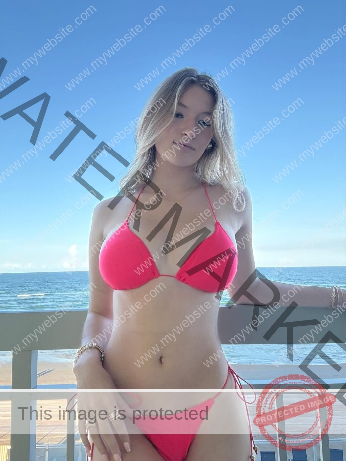 Mckenna Panos Mckenna Panos stands on a balcony by the beach in a bright pink bikini, ocean and blue sky behind her.