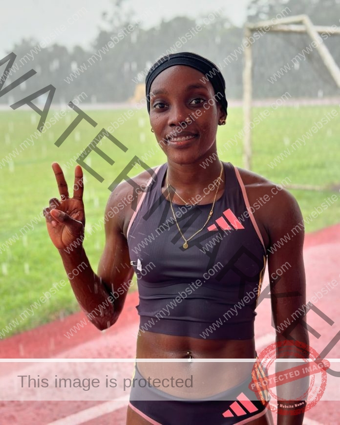 Milagros Duran Garcia Milagros Duran Garcia, a track and field athlete from the Dominican Republic, stands smiling on a wet track in rain, flashing a peace sign. She wears a dark sports bra, shorts, headband, and necklace.