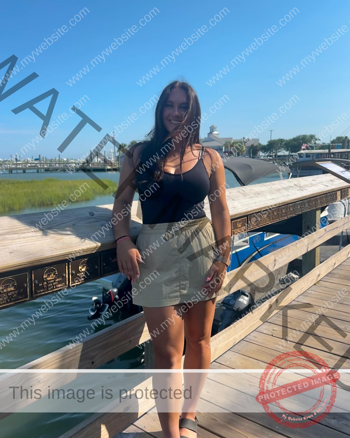 rosa-gergely-wake-forest-th-ro_gerg-1983 Rosa Gergely, javelin thrower from Wake Forest, a woman in a black tank top and beige skirt smiles on a boardwalk by the water.