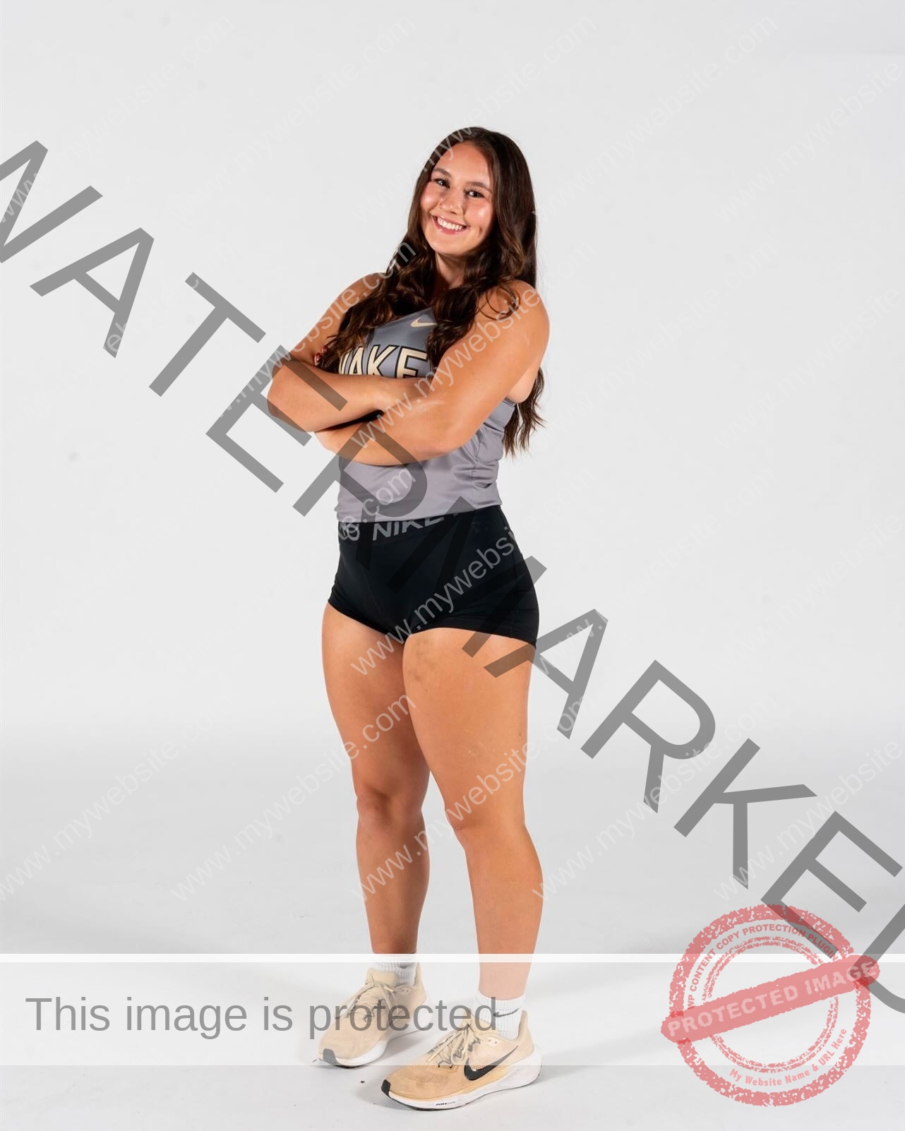 rosa-gergely-wake-forest-th-ro_gerg-1994 Rosa Gergely, javelin thrower from Wake Forest, stands with arms crossed, smiling in a gray Nike top and black shorts.