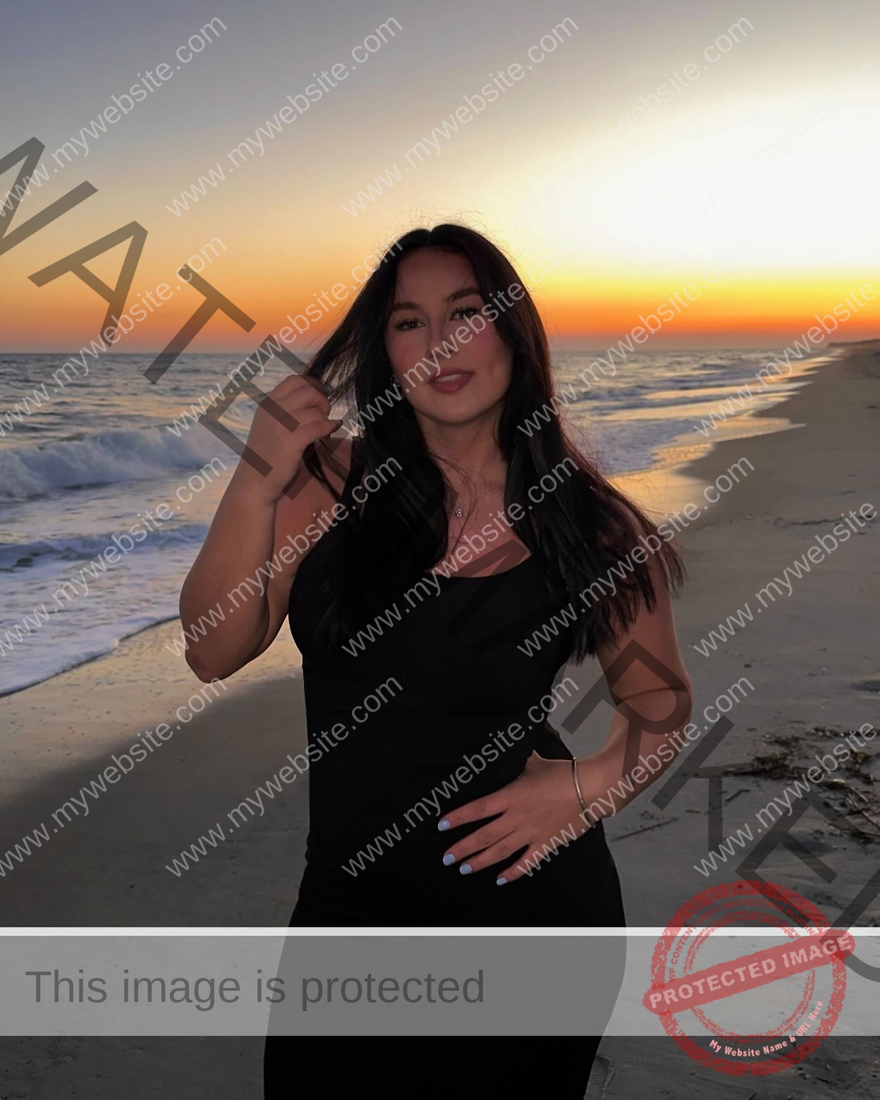 rosa-gergely-wake-forest-th-ro_gerg-1995 Rosa Gergely, javelin thrower from Wake Forest, stands on a beach at sunset in a black dress, touching her hair and looking relaxed.