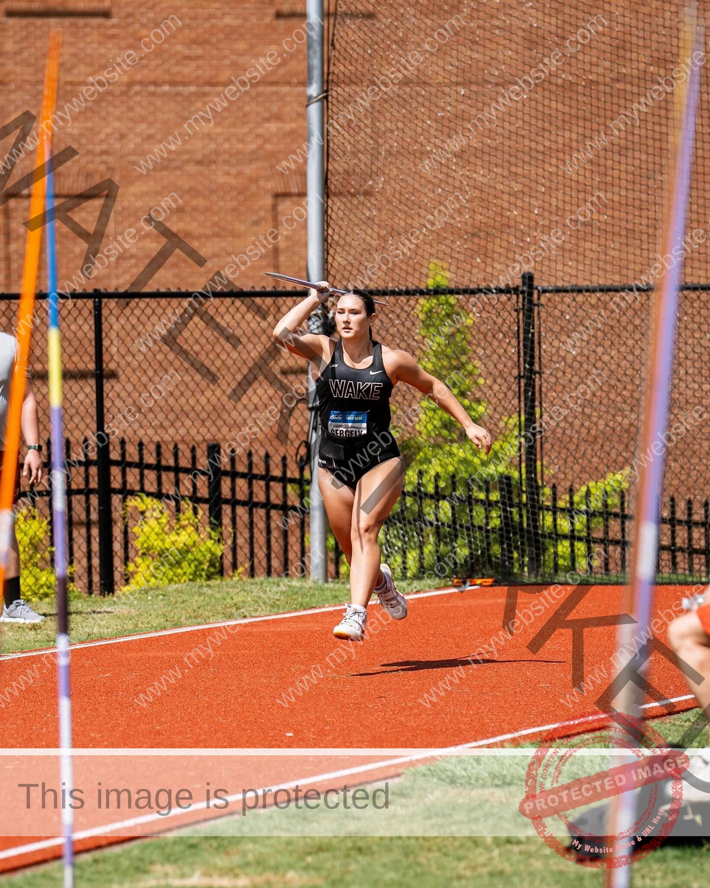 rosa-gergely-wake-forest-th-ro_gerg-2007 Rosa Gergely, javelin thrower from Wake Forest, prepares to throw a javelin on a track; other javelins and a brick wall are visible.