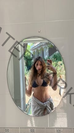 533954902_18080345953922711_6676755869916727704_n Norma Grezio, track and field star from Italy, takes a mirror selfie in a bikini top and towel indoors with a garden behind her.