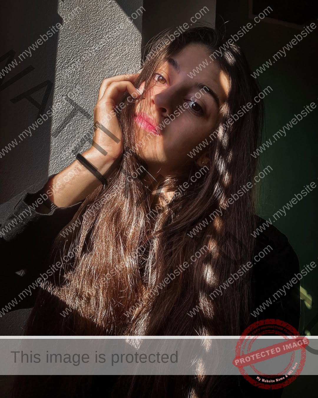 anabel-vitale-italy-anabelvitale-0389 Anabel Vitale, track and field star from Italy, sits in striped sunlight, head on hand, gazing thoughtfully at the camera.