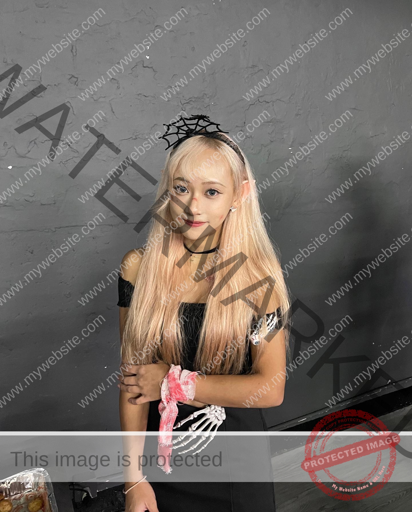 chan-pui-kei-hong-kong-chanpuikeii-02869 Chan Pui Kei, track and field star from Hong Kong, with long blonde hair in a black off-shoulder dress, spiderweb headband, smiles.