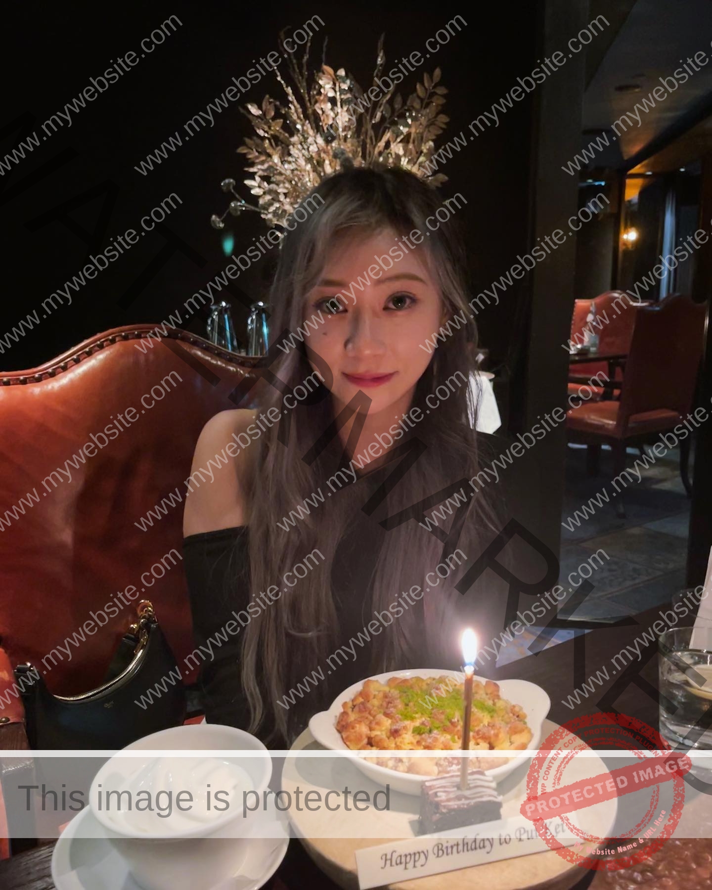 chan-pui-kei-hong-kong-chanpuikeii-02900 Chan Pui Kei, track and field star from Hong Kong, with long wavy hair, celebrates at a table with dessert, ice cream, and a lit candle.
