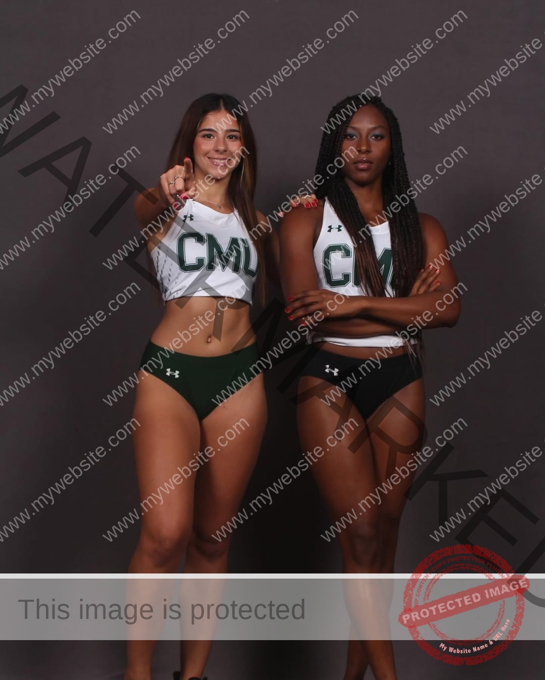 emma-deana-spain-emmadeana-15443 Emma Deana, track and field star from Spain, stands with another female athlete in CMU uniforms; one smiles and points, the other is confident with arms crossed.