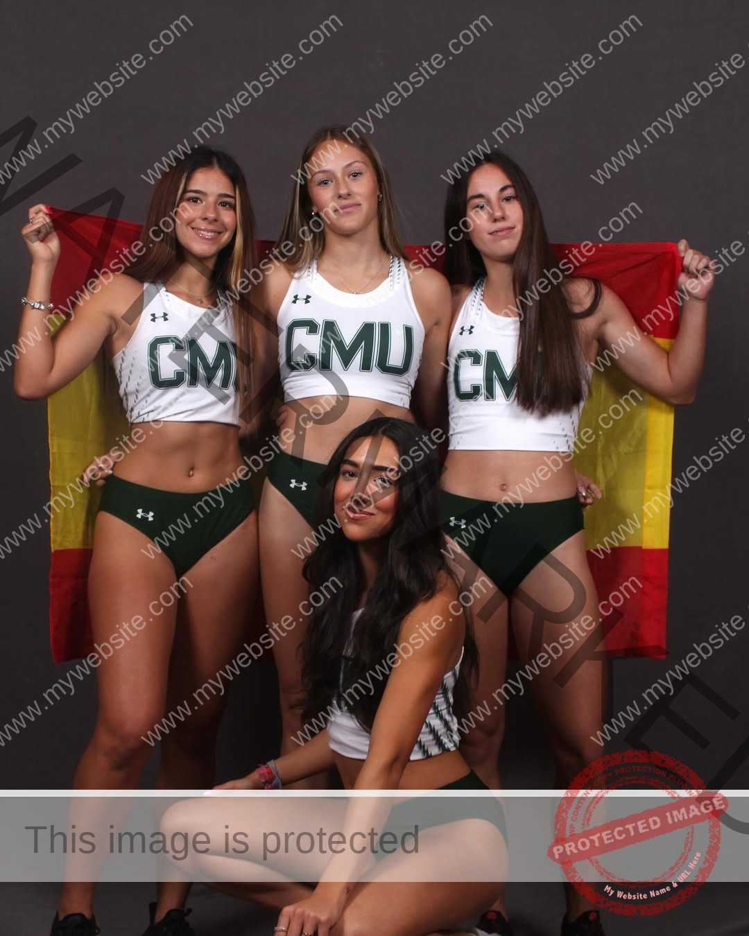 emma-deana-spain-emmadeana-15447 Emma Deana, track and field star from Spain, poses with three teammates in CMU uniforms; two hold a Spanish flag, all smiling.