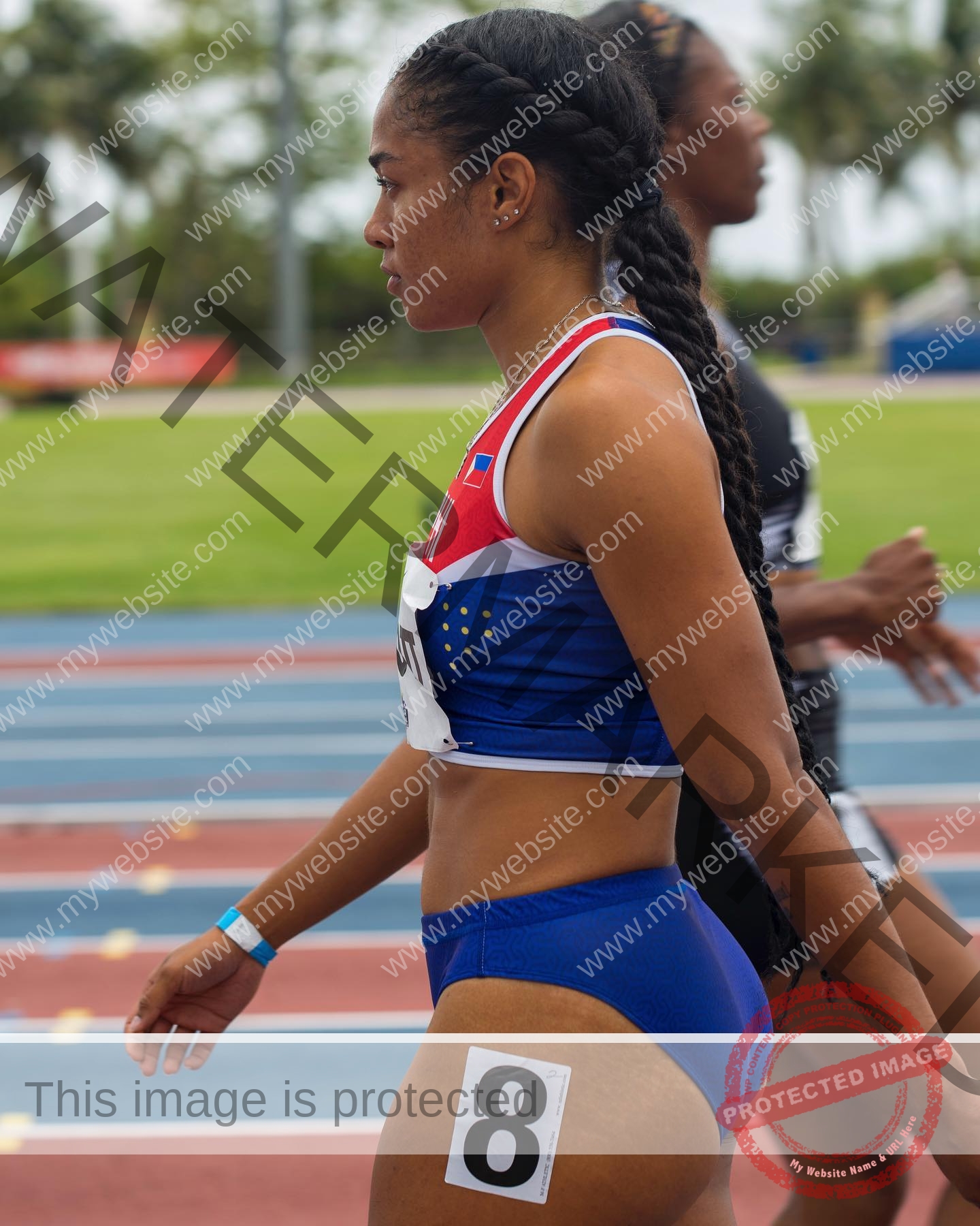 kristina-knott-philippines-knottyourcheese-x-18247 Kristina Knott, track and field star from Philippines, with long braids in a blue, red, and white uniform, number 8 shorts on track.
