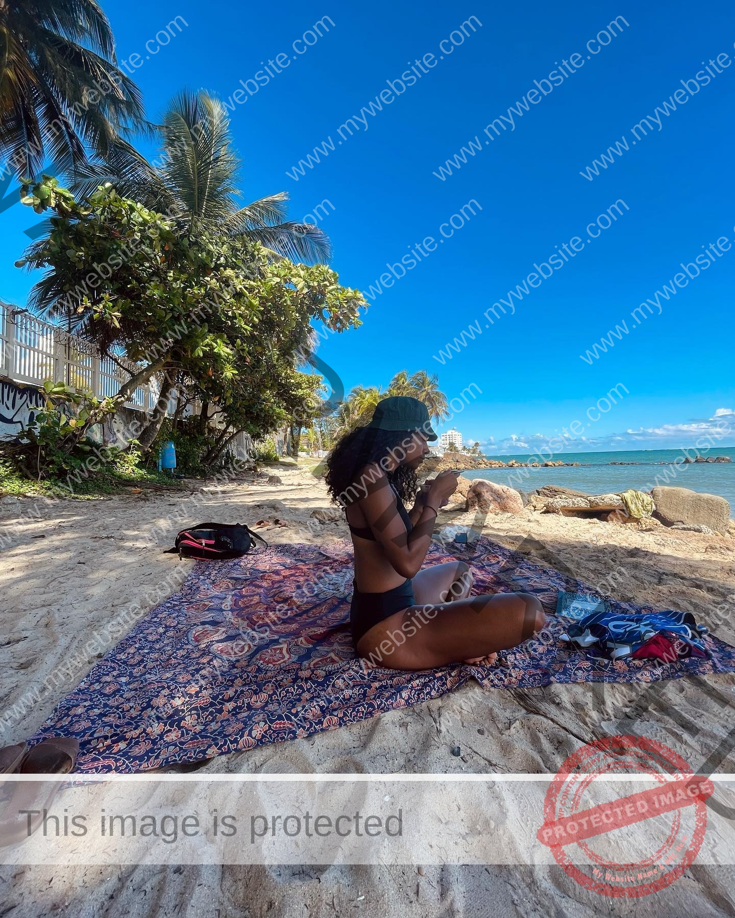 kristina-knott-philippines-knottyourcheese-x-18268 Kristina Knott, track and field star from Philippines, sits cross-legged on a beach blanket, drinking from a cup by the ocean.