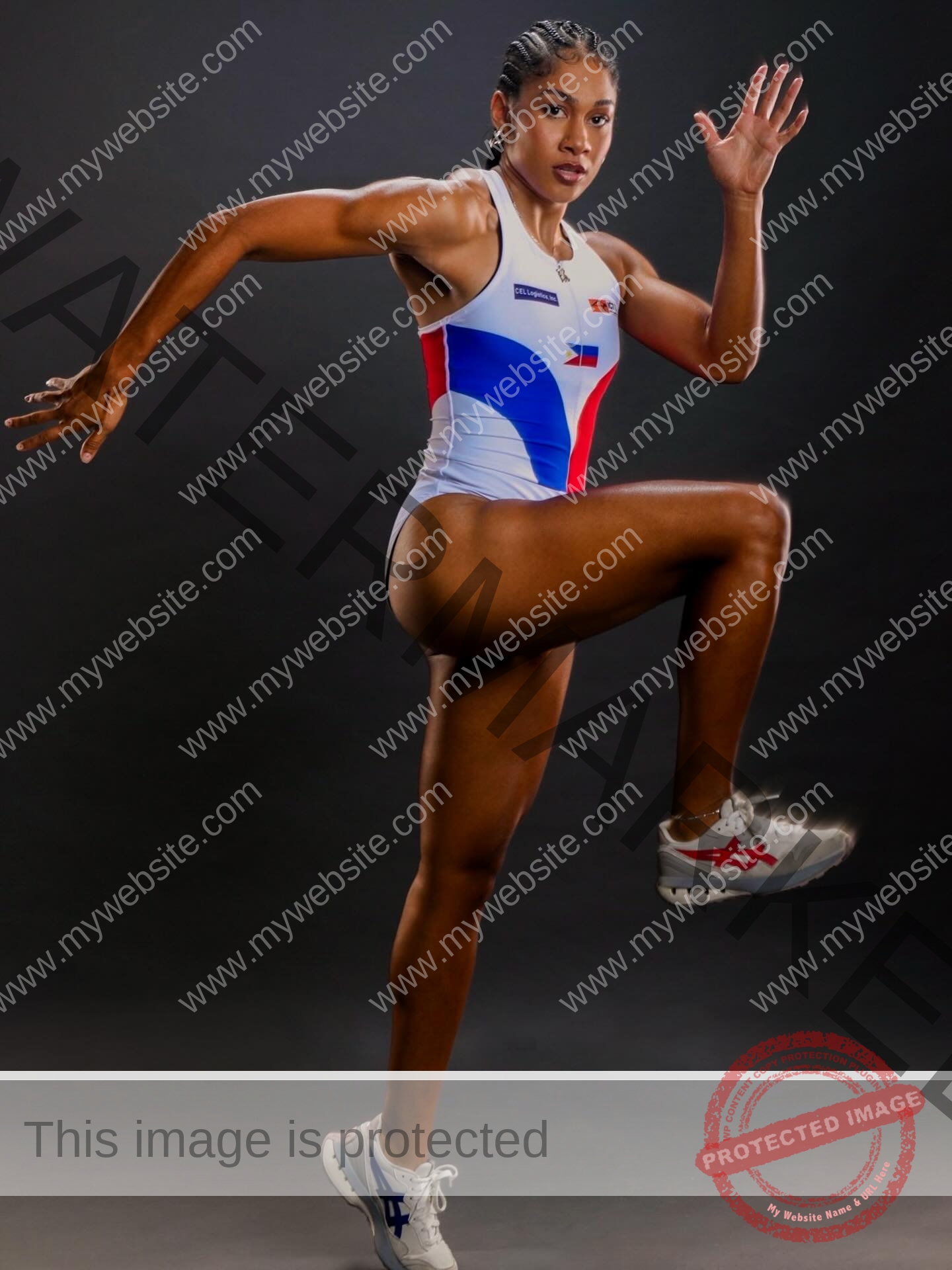 kristina-knott-philippines-knottyourcheese-x-18619 Kristina Knott, track and field star from Philippines, in blue, white, red uniform poses mid-stride on dark background, strong and athletic.