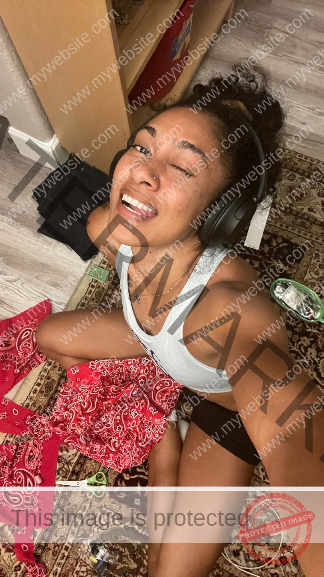 kristina-knott-philippines-knottyourcheese-x-19130 Kristina Knott, track and field star from Philippines, wears headphones and sits on a rug, smiling amid sewing supplies and red bandanas.