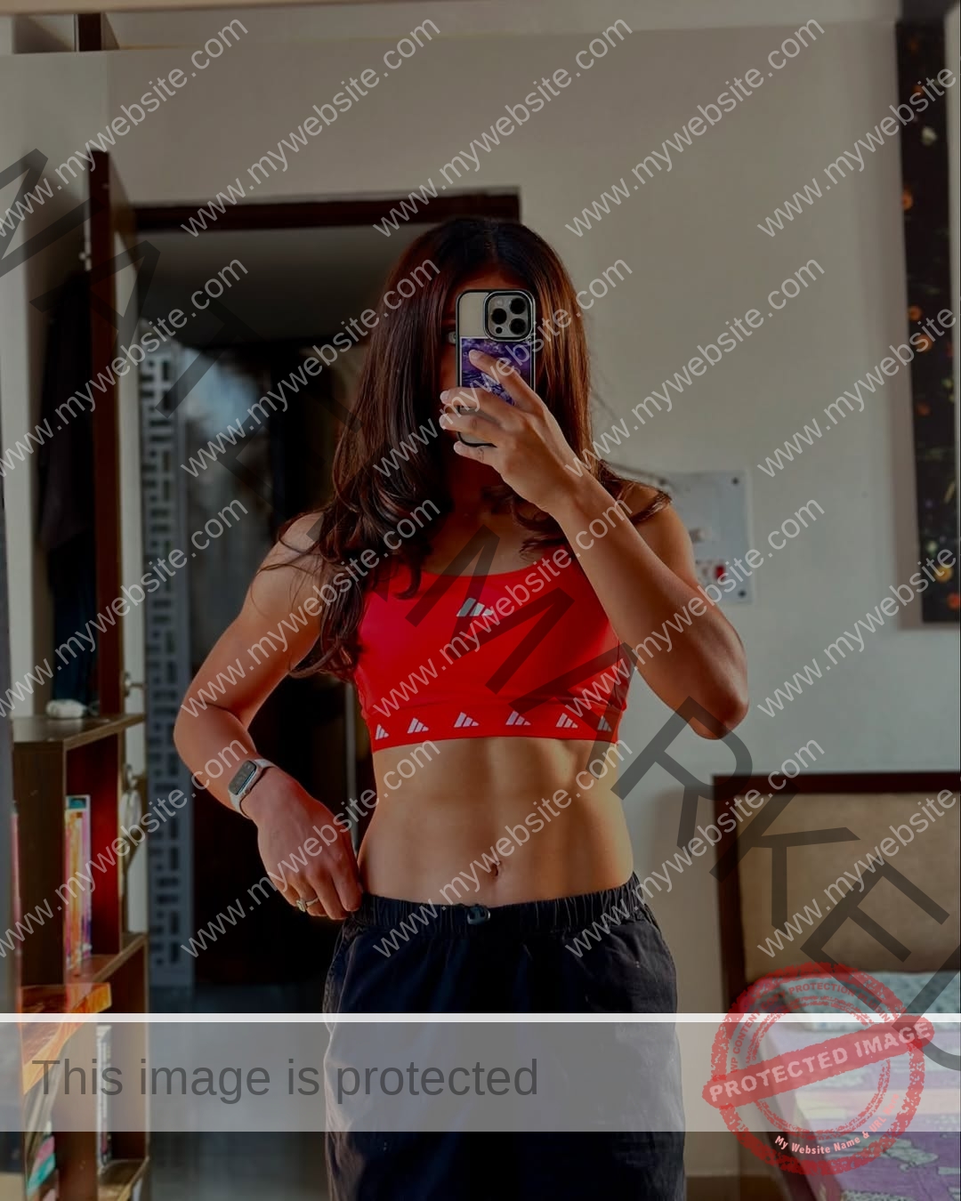 niharika-vashisht-india-niharika.vashhisht-05749 Niharika Vashisht, track and field star from India, takes a mirror selfie in a red sports bra and black shorts, showing toned muscles.