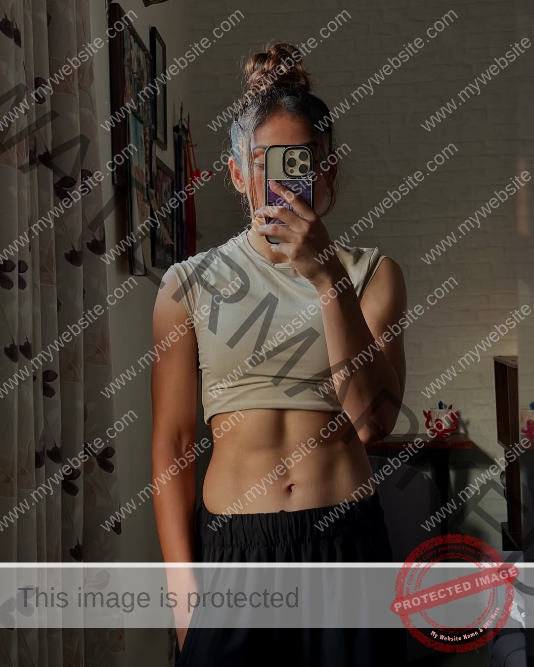 niharika-vashisht-india-niharika.vashhisht-06169 Niharika Vashisht, track and field star from India, flaunts defined abs in a mirror selfie, beige top, black pants, hair tied up.