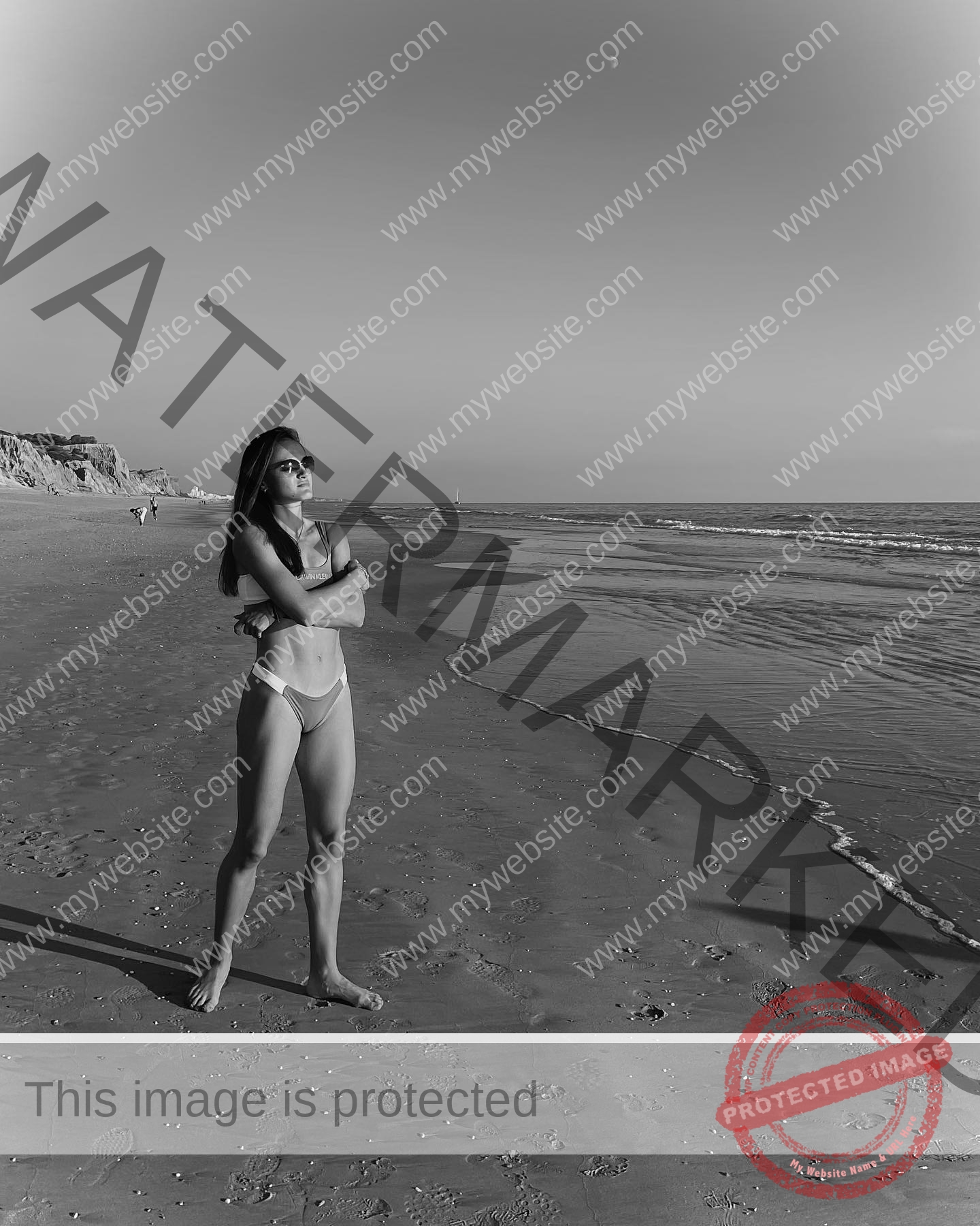 polina-tkalich-russia-p_a_tkalich-10909 Polina Tkalich, track and field star from Russia, stands barefoot in sunglasses and bikini on an empty beach, gazing at the sea.