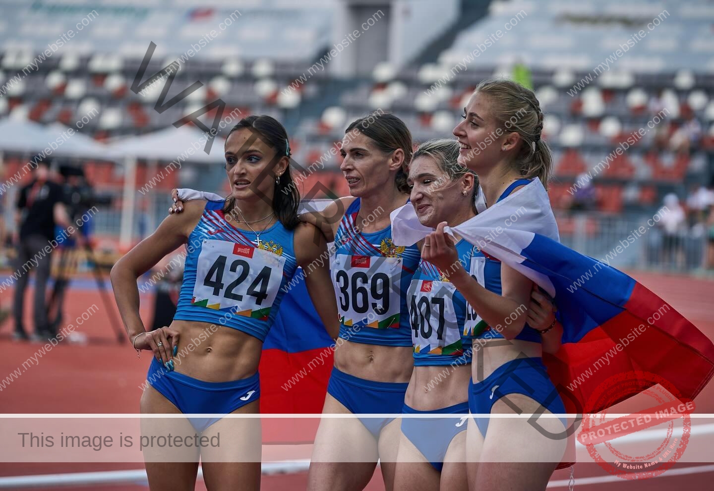 polina-tkalich-russia-p_a_tkalich-11136 Polina Tkalich, track and field star from Russia, with teammates in blue uniforms holding a flag; empty stands behind them.