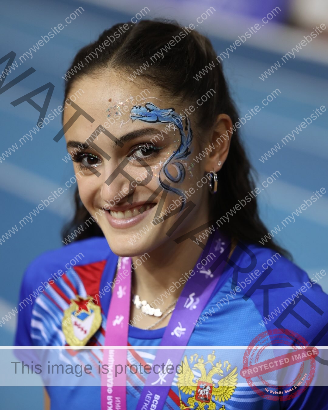 polina-tkalich-russia-p_a_tkalich-11177 Polina Tkalich, track and field star from Russia, smiles in blue uniform, medal ribbon, dragon face paint, sparkles; track behind.